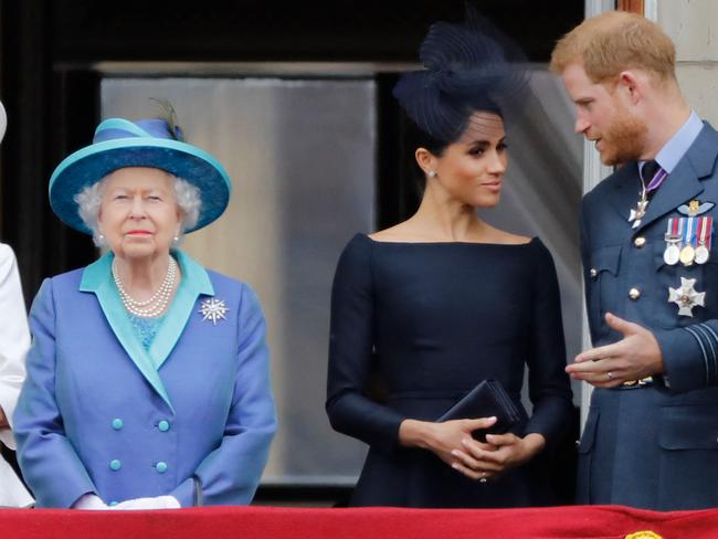 (FILES) In this file photo taken on July 10, 2018 (L-R) Britain's Prince Charles, Prince of Wales, Britain's Camilla, Duchess of Cornwall, Britain's Queen Elizabeth II, Britain's Meghan, Duchess of Sussex and Britain's Prince Harry, Duke of Sussex, stand on the balcony of Buckingham Palace to watch a military fly-past to mark the centenary of the Royal Air Force (RAF). - Britain's Prince Harry will relinquish his honorary military appointments and patronages after confirming to Queen Elizabeth II that he and wife Meghan Markle will not return as working royals, Buckingham Palace announced on February 19, 2021. (Photo by Tolga AKMEN / AFP)