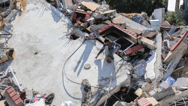 People inspect the damage to their homes following Israeli air strikes in Rafah, Gaza. Picture: Getty Images