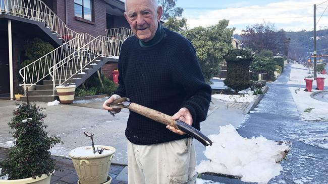 Trevor Ewington shovels snow off the footpath in Trevallyn. PICTURE: PATRICK GEE