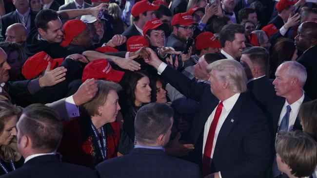 President-elect Donald Trump shakes hands during an election night rally. Picture: AP/Evan Vucci