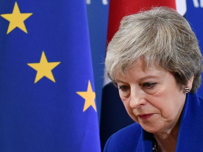 TOPSHOT - Britain's Prime Minister Theresa May leaves after a press conference following a special meeting of the European Council to endorse the draft Brexit withdrawal agreement and to approve the draft political declaration on future EU-UK relations on November 25, 2018 in Brussels. - The European Union's top official urged British lawmakers to ratify the Brexit deal Prime Minister Theresa May has negotiated with European leaders, warning it will not be modified. "This is the best deal possible for Britain, this is the best deal possible for Europe. This is the only deal possible," Jean-Claude Juncker, the president of the European Commission, said after a Brussels summit. (Photo by Philippe LOPEZ / AFP)