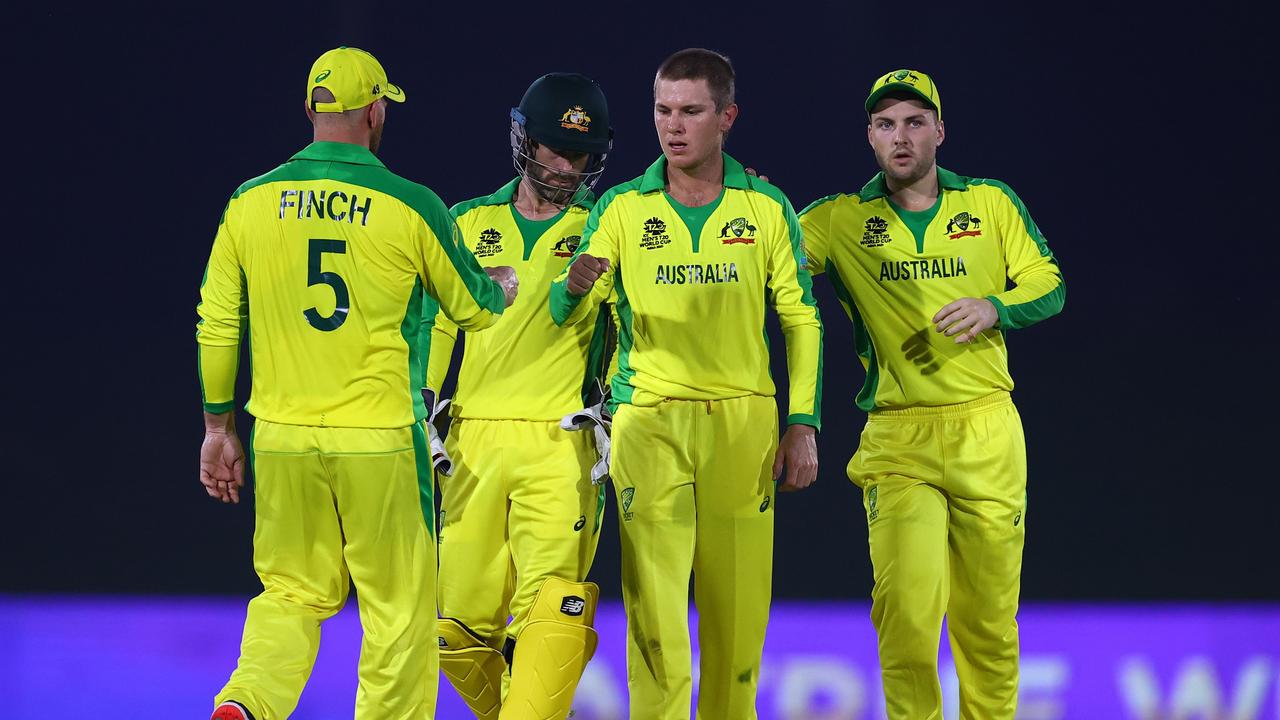 ABU DHABI, UNITED ARAB EMIRATES - OCTOBER 18: Adam Zampa (2r) of Australia receives the plaudits from captain Aaron Finch (l) after capturing the wicket of Kane Williamson of New Zealand during the New Zealand and Australia warm Up Match prior to the ICC Men's T20 World Cup at on October 18, 2021 in Abu Dhabi, United Arab Emirates. (Photo by Michael Steele-ICC/ICC via Getty Images)