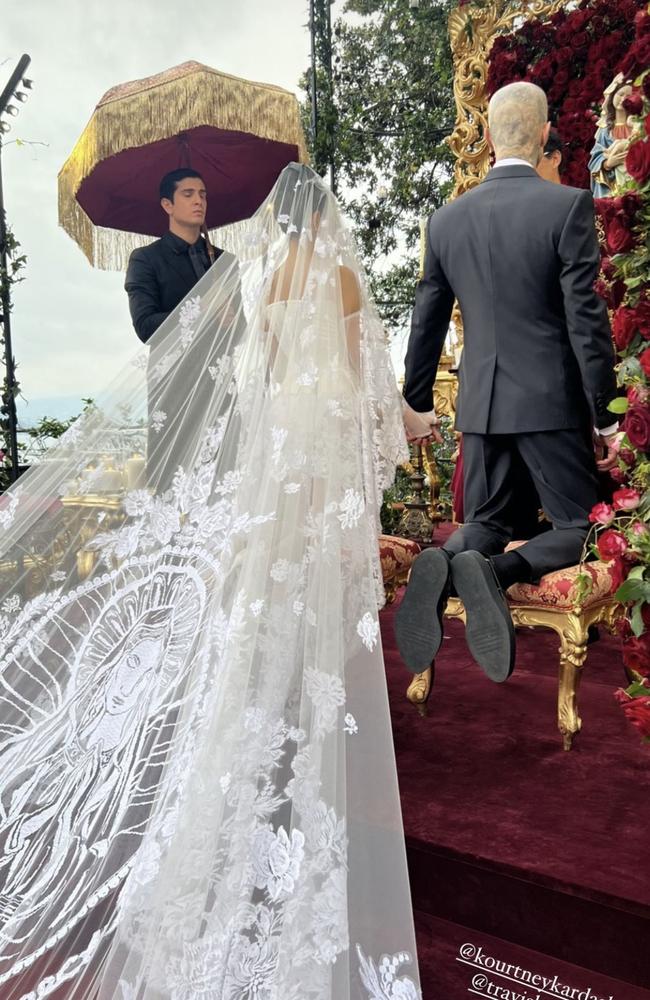 Kourtney’s outfit featured an elaborate veil with a train.