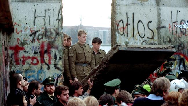 East German border guards at a breach in the Berlin Wall on November 11, 1989.