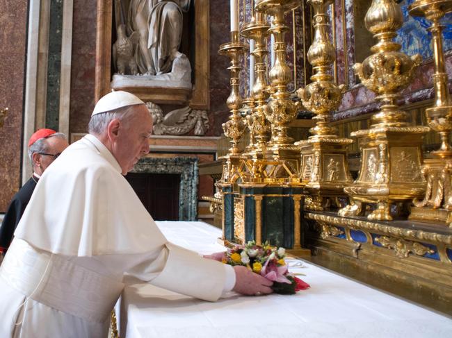 Pope Francis (C) laying a wreath prior a prayer at Rome's Santa Maria Maggiore basilica early on his first full day as the head of the world's 1.2 billion Catholics. Picture: AFP / OSSERVATORE ROMANO/HO