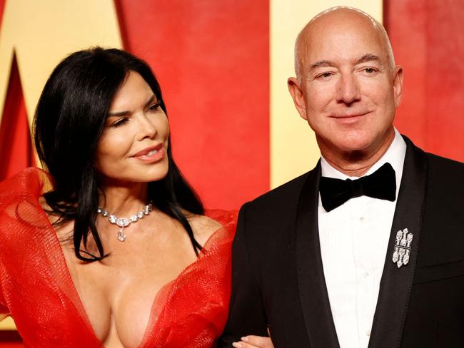 Executive chairman of Amazon Jeff Bezos and girlfriend US actress Lauren Sanchez attend the Vanity Fair Oscars Party at the Wallis Annenberg Center for the Performing Arts in Beverly Hills, California, on March 10, 2024. (Photo by Michael TRAN / AFP)