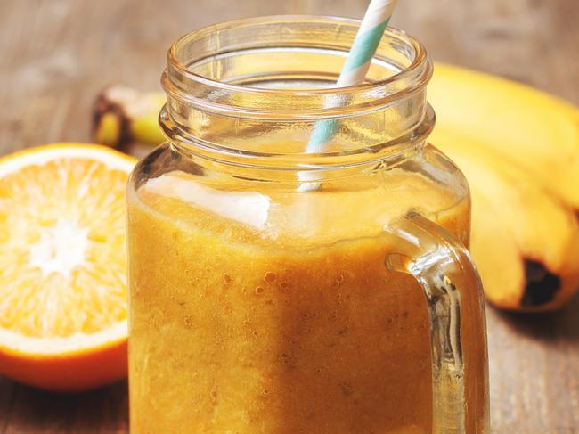 Gold Coast Bulletin - Good Health Guide - October 2017 - Juice Cleanse.Dietary breakfast. Smoothies orange banana in a mason jar, half an orange, bananas on a wooden background