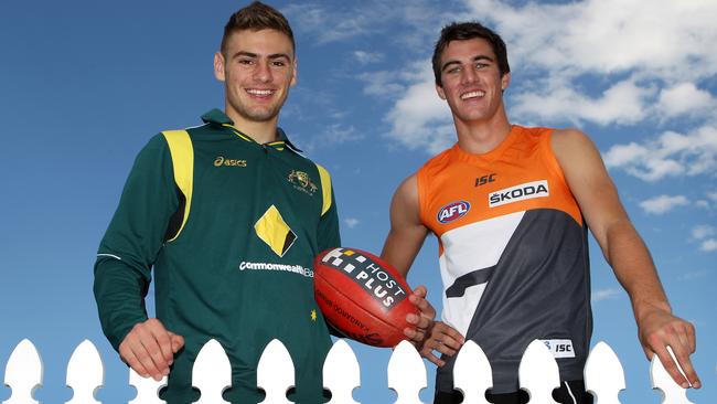 Stephen Coniglio and Pat Cummins swap shirts.