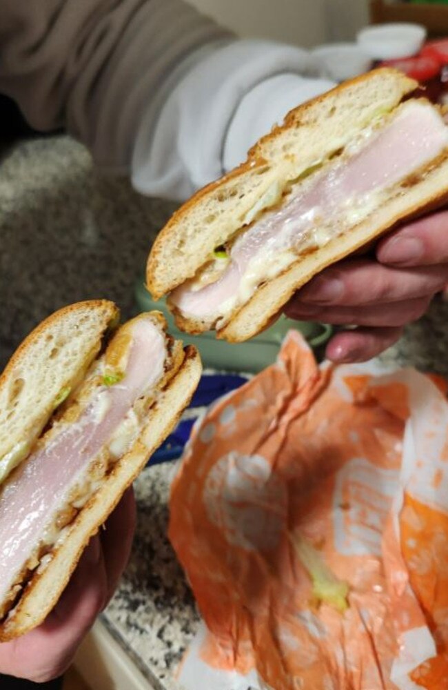 Images of the raw chicken burger served to a customer at a Brisbane Hungry Jacks.