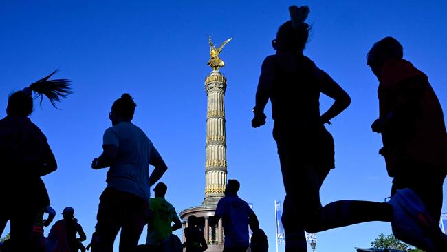 Runners make their way past the landmark Victory Column (Siegessaeule) as they compete in the 50th edition of the Berlin Marathon in Berlin, Germany on September 29, 2024. (Photo by John MACDOUGALL / AFP)