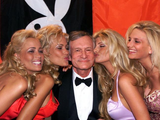 Hefner receives kisses from Playboy playmates during the 52nd Cannes Film Festival. Pic: AP.