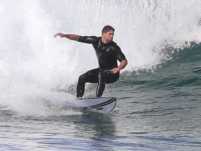 Chris Hemsworth carving up the surf in Byron Bay. Picture: Media Mode