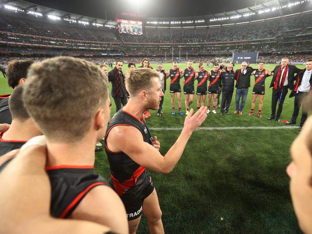 Essendon captain Dyson Heppell fires up the past and present players before the match. Picture: Getty Images
