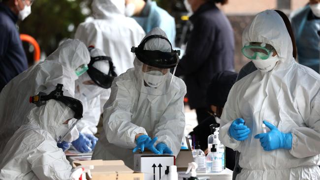 Medical staff take samples from people at a building where 46 people were confirmed to have the coronavirus in Seoul, South Korea. Picture: Getty Images