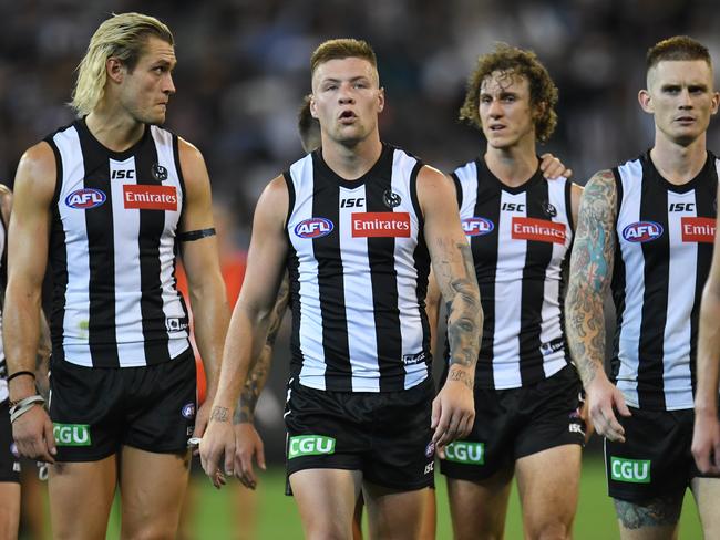 Jordan de Goey (third from left) of the Magpies reacts after the Round 1 AFL match between the Collingwood Magpies and the Geelong Cats at the MCG in Melbourne, Friday, March 22, 2019. (AAP Image/Julian Smith) NO ARCHIVING, EDITORIAL USE ONLY