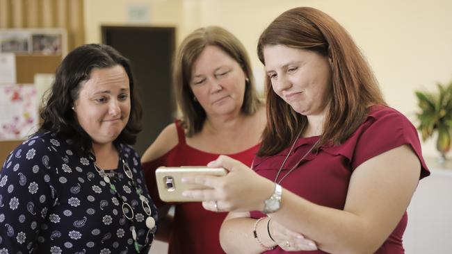 Supporters, Bronwyn Dendle, Marie Austin and Angela Fredericks having a face time conversation with Nades and family. Picture: Mark Cranitch.