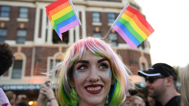 A SSM Yes voter attempts to use her rainbow antennae to take over Andrew Hastie’s brain and turn him from ex-commando to rainbow warrior. Picture: AAP