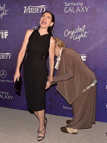 What’s going on here is anyone’s guess ... but actresses Cloris Leachman and Emmy-winner Julianna Margulies have each other in stitches as they attend Variety and Women in Film Emmy Nominee party. Picture: Getty