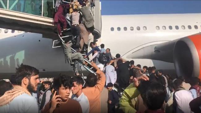 Civilians try to board planes at Kabul airport in 2021 to flee the Taliban. Picture: Twitter