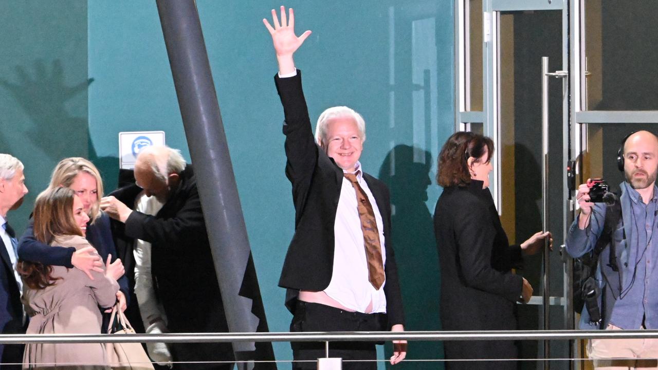 Julian Assange waved to the crowd after stepping off the plane. Picture: NewsWire / Martin Ollman