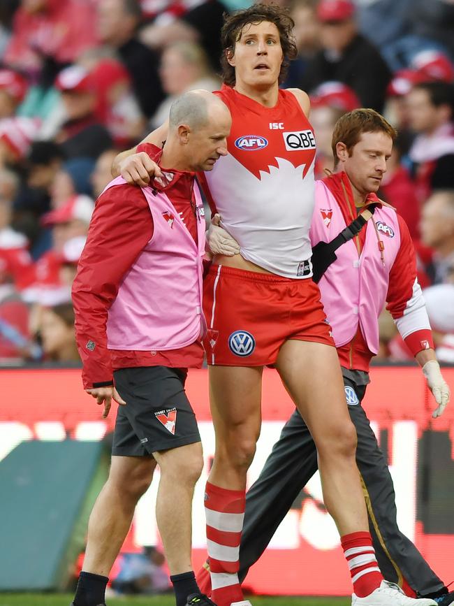 Kurt Tippett of the Swans is helped off the field in 2017 prior to his retirement. Picture: AAP Image/David Moir