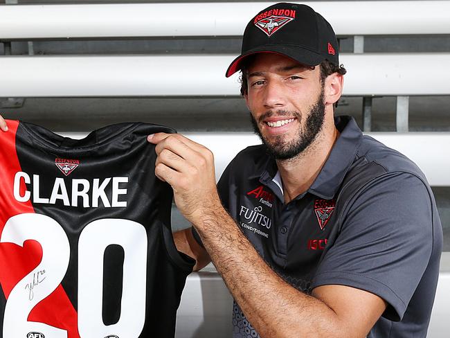 Essendon recruit Zac Clarke is presented with his jumper by fan Eugene 4yrs at their family day Melbourne Showgrounds. Picture : Ian Currie