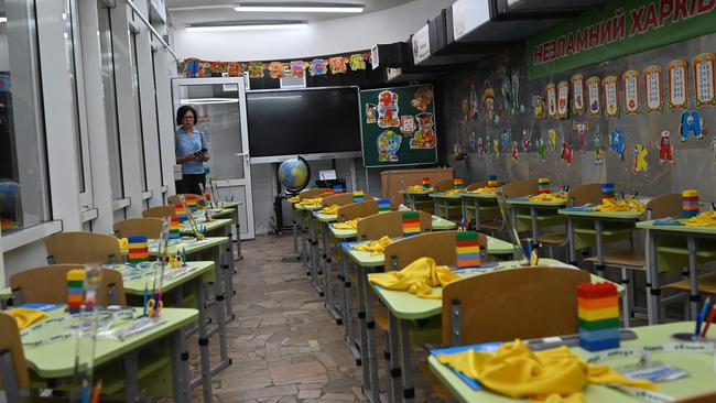 A woman looks at a classroom prepared for pupils in a subway station on a day of the new school year in Ukraine. Picture: Sergey Bobok/AFP