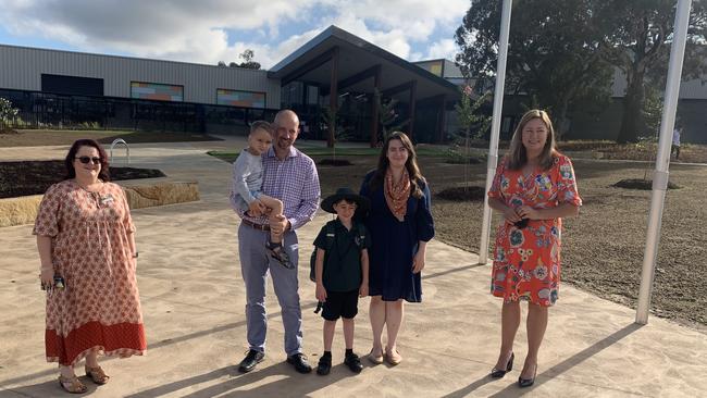 Principal Annamaria Zuffo with parents Nathan and Jessica Ward and their children Toby (with Nathan) and Ethan with ACT Education Minister Yvette Berry. Picture: Julia Kanapathippillai