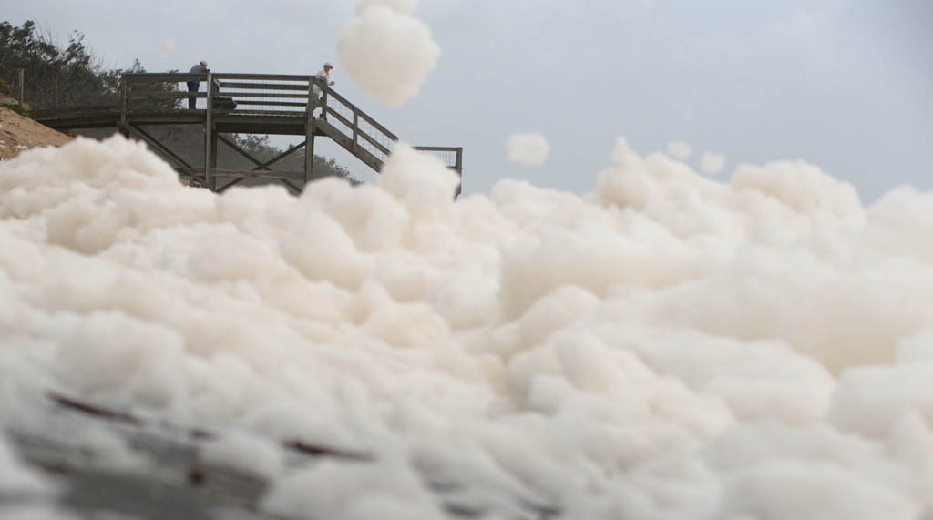 Foam covers Maroochydore Beach after heavy rain and large seas. Picture: Brett Wortman