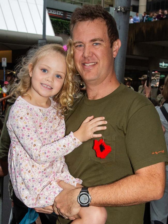 Thousands of people have braved the rain to gather in Brisbane for Anzac Day services. Picture: Grace Kessels