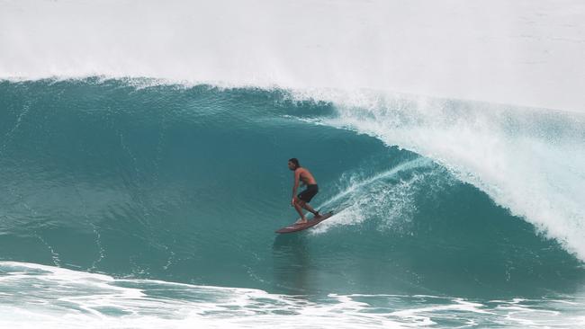 The heavy swells have been a blessing for surfers. Photograph: Jason O'Brien