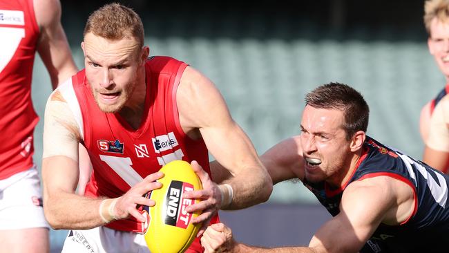 Rooster Andrew Moore under pressure from Norwood's Richard Douglas. Picture: Sarah Reed