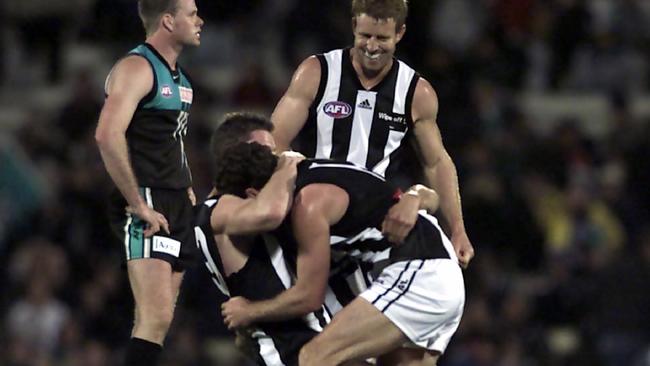 Collingwood players celebrate a big upset win over minor premiers Port Adelaide in the 2002 qualifying final.