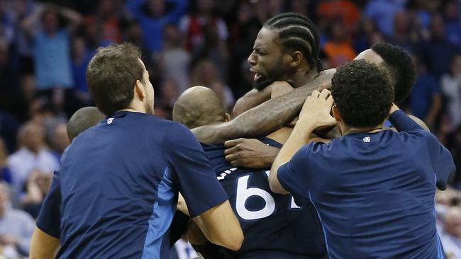 Minnesota Timberwolves’ Andrew Wiggins, centre, is mobbed by his teammates after hitting the game winning shot at the buzzer.