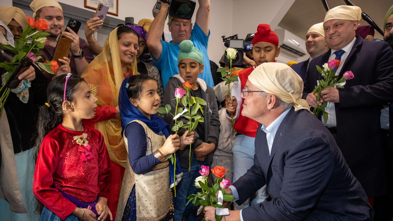 Mr Morrison at a multicultural community event in Officer greeting children from the Sikh community. Picture: Jason Edwards