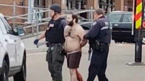 The suspected gunman is led away from the scene of the shooting. Picture: Twitter