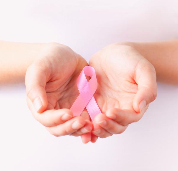holding pink breast cancer awareness ribbon