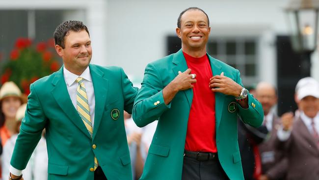 And that makes five: Tiger Woods is awarded the Green Jacket by Masters champion Patrick Reed this morning. Picture: Kevin C. Cox/Getty