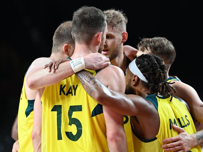 31 July 2021, Japan, Saitama: Basketball: Olympics, Australia - Germany, Preliminary Round, Group B, Matchday 3 at Saitama Super Arena. Australia's players hug each other during the match. Photo: Swen PfÃ¶rtner/dpa (Photo by Swen PfÃ¶rtner/picture alliance via Getty Images)