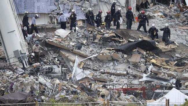 Search and rescue teams look for possible survivors and recovering remains in the partially collapsed apartment block. Picture: Joe Raedle/Getty Images