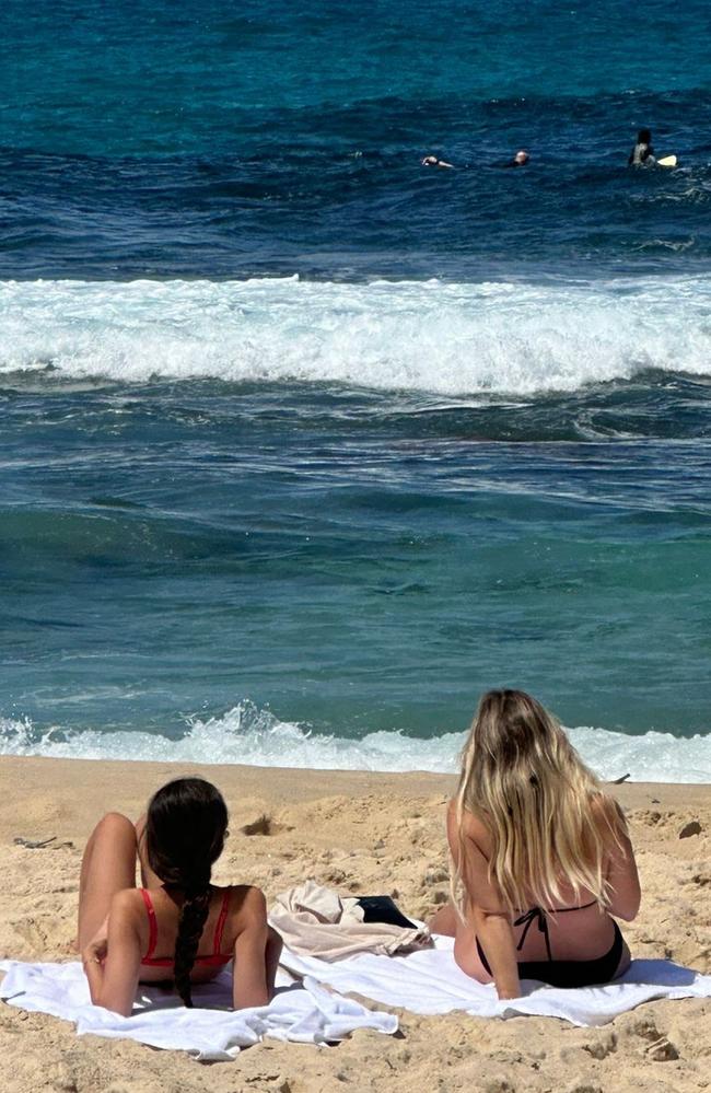 Olivia Rodrigo (left) soaks up the rays at Bronte Beach this afternoon. Picture: Willow Berry