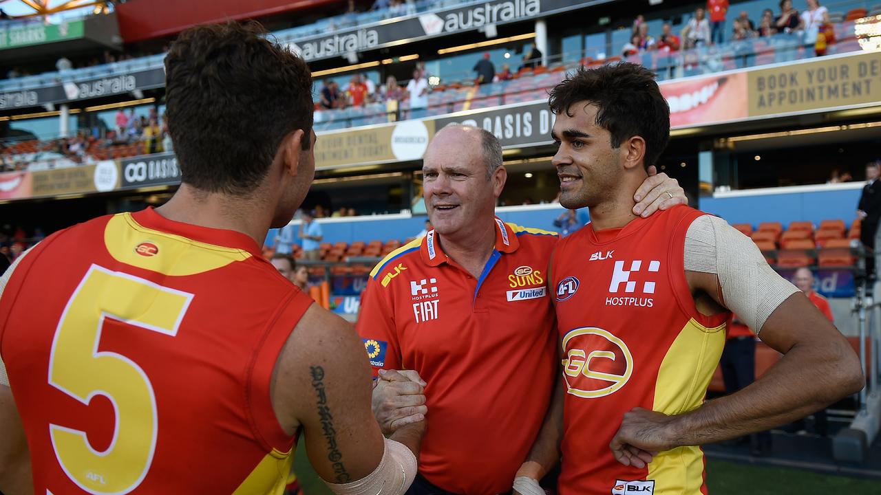 Martin celebrates a win with Rodney Eade and Jarrod Harbrow while with the Suns in 2016. Martin says Harbrow had a huge influence on him when he started on the Gold Coast.