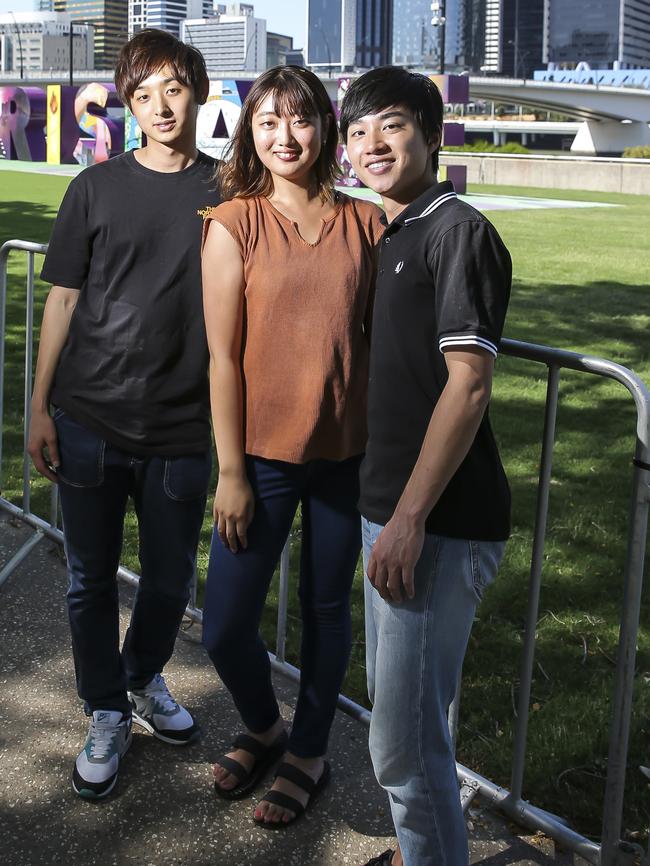 Japanese tourists Kosuke Urata, Arisa Sugaya and Eisuke Nasuno at South Bank in Brisbane. Picture: Mark Cranitch