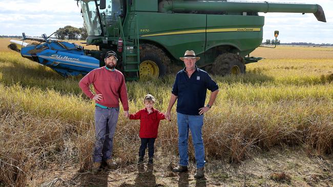 Three generations of rice growers harvesting a bumper crop in the Riverina. Josh Small with his son Charlie, 4, and father Geoff at "Billinudgel", near Deniliquin, NSW. Picture: Yuri Kouzmin