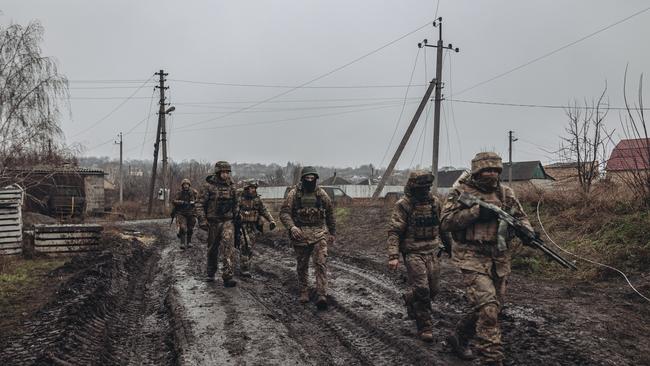 Ukrainian soldiers walk to the frontline in Bakhmut.