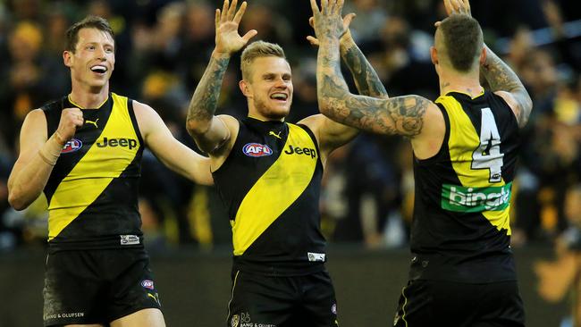 Richmond’s Dylan Grimes, Brandon Ellis and Dystin Martin celebrate a goal against Geelong. Picture: Mark Stewart