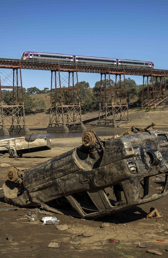 Burnt-out cars litter the Werribee River area. Picture: Jake Nowakowski