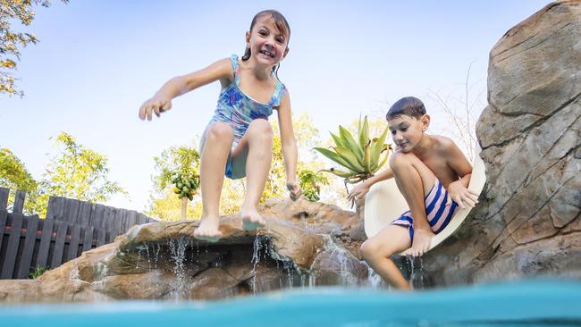 Siblings Tobin 11, and Isabella Carnes 7 play in their backyard pool. Picture: Lachie Millard