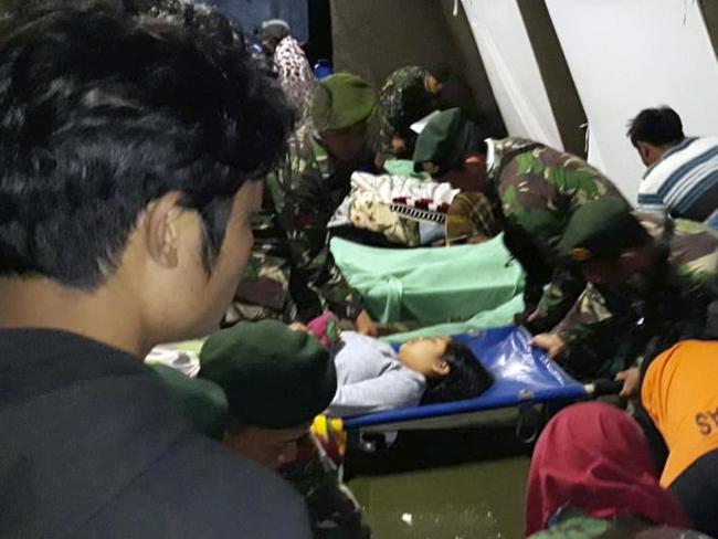 Indonesian soldiers tend to the injured. Picture: AP.