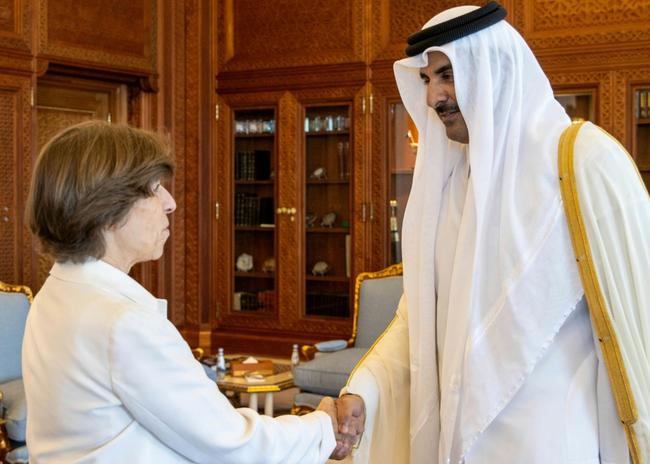 Emir Sheikh Tamim bin Hamad al-Thani welcomes French Foreign Minister Catherine Colonna at the Royal Palace in Doha